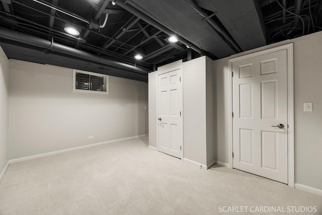 finished basement featuring baseboards, carpet, and visible vents
