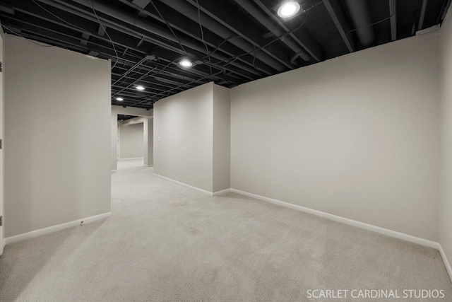 finished below grade area with baseboards and carpet flooring