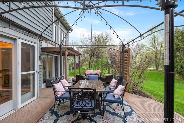 view of patio / terrace with outdoor dining area, a wooden deck, and an outdoor hangout area