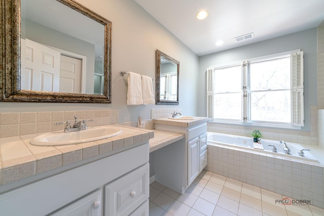 full bath with tile patterned floors, a garden tub, visible vents, and a sink