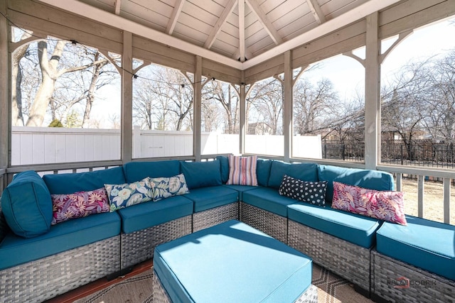 sunroom with a healthy amount of sunlight, wooden ceiling, and lofted ceiling with beams