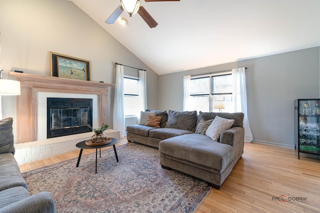 living area with a ceiling fan, wood finished floors, baseboards, and a wealth of natural light