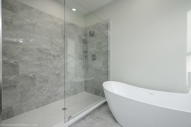 full bath featuring a soaking tub and a walk in shower