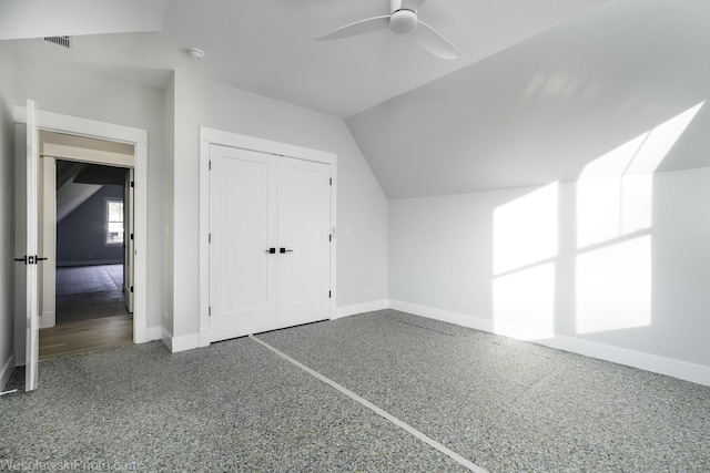 additional living space with vaulted ceiling, visible vents, baseboards, and ceiling fan