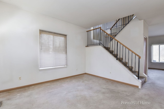 stairs featuring baseboards and carpet