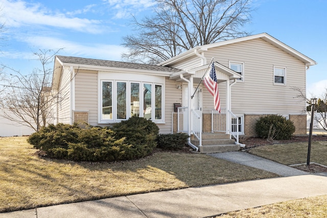 tri-level home with a front lawn