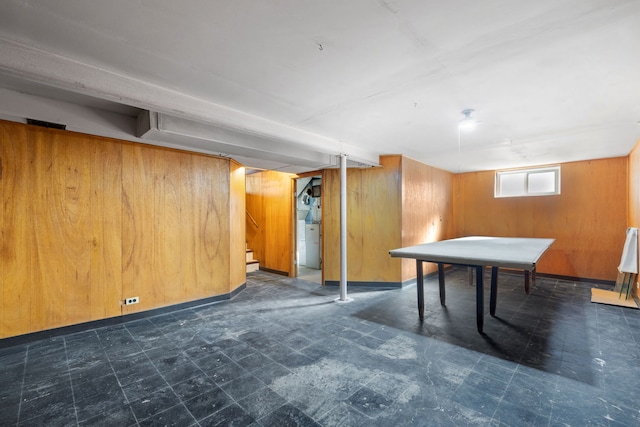 rec room featuring tile patterned floors, washer / clothes dryer, and wooden walls