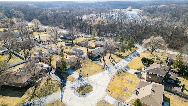 aerial view featuring a wooded view and a residential view