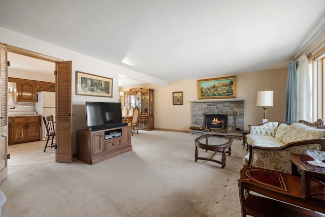 living room with light colored carpet and a fireplace