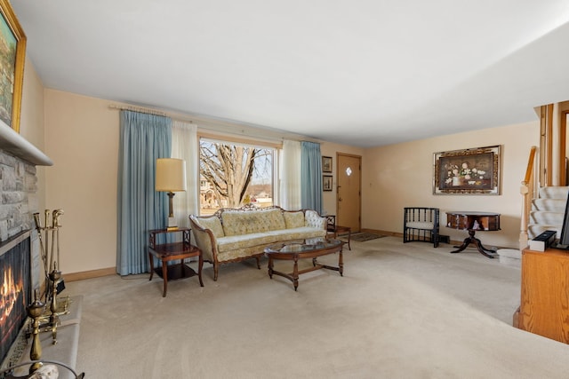 carpeted living area featuring a fireplace and baseboards