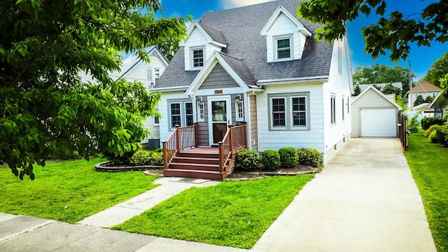 319 S 3rd St, Watseka, IL 60970 - cape cod-style house with concrete driveway, an outdoor structure, a garage, a front lawn, and a shingled roof