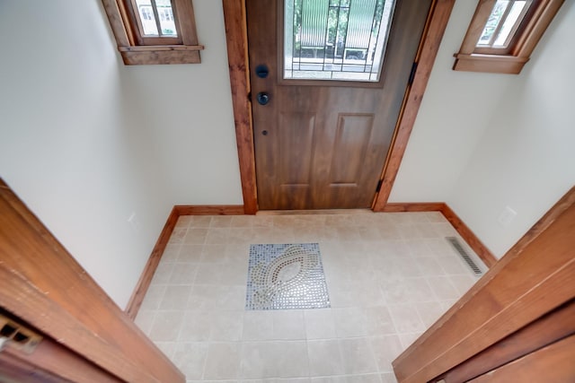 319 S 3rd St, Watseka, IL 60970 - entryway featuring healthy amount of natural light and baseboards
