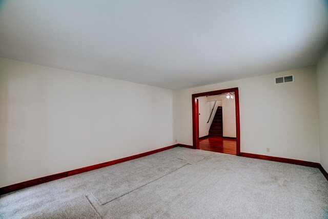 319 S 3rd St, Watseka, IL 60970 - spare room with stairway, light carpet, and baseboards