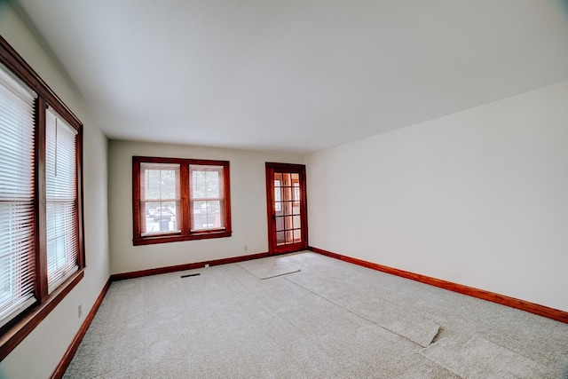 319 S 3rd St, Watseka, IL 60970 - spare room featuring light colored carpet and baseboards