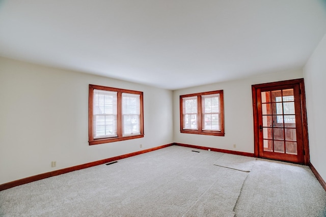 319 S 3rd St, Watseka, IL 60970 - empty room with carpet, healthy amount of natural light, and baseboards