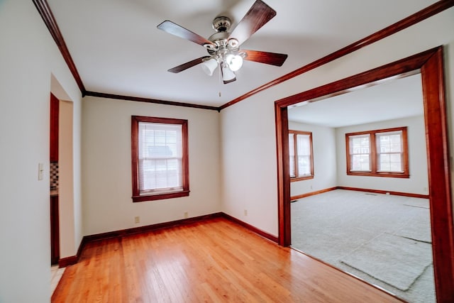 319 S 3rd St, Watseka, IL 60970 - spare room with baseboards, plenty of natural light, light wood-style floors, and crown molding
