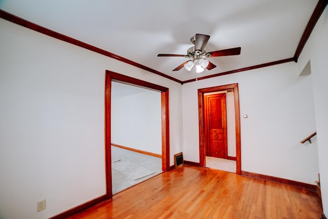 319 S 3rd St, Watseka, IL 60970 - empty room featuring baseboards, light wood-type flooring, ceiling fan, and ornamental molding