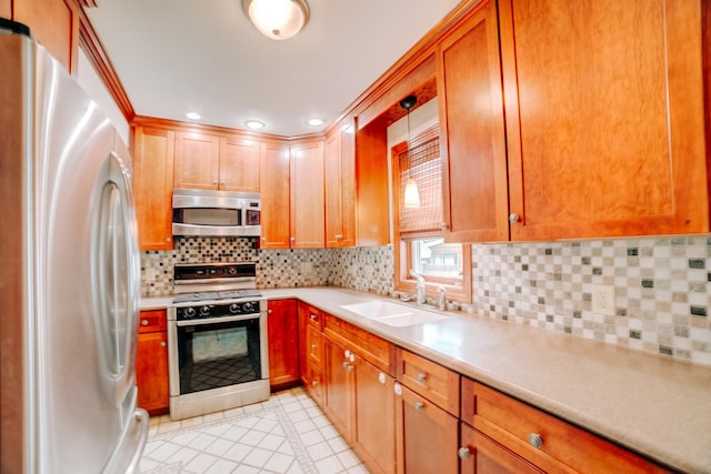 319 S 3rd St, Watseka, IL 60970 - kitchen featuring appliances with stainless steel finishes, a sink, light countertops, backsplash, and recessed lighting
