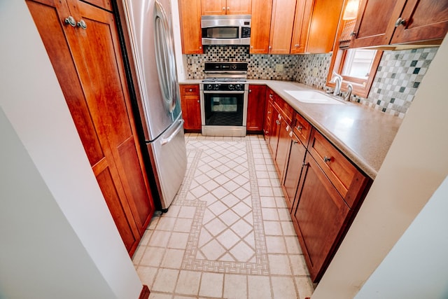 319 S 3rd St, Watseka, IL 60970 - kitchen with appliances with stainless steel finishes, a sink, backsplash, and light tile patterned floors