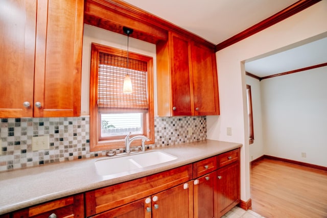 319 S 3rd St, Watseka, IL 60970 - kitchen with a sink, crown molding, light countertops, backsplash, and baseboards