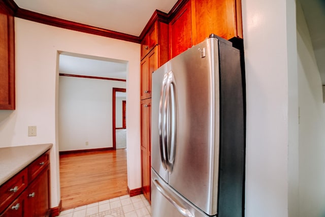 319 S 3rd St, Watseka, IL 60970 - kitchen featuring freestanding refrigerator, ornamental molding, light floors, baseboards, and light countertops