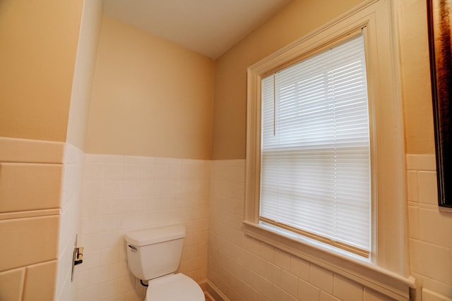 319 S 3rd St, Watseka, IL 60970 - half bathroom featuring toilet, wainscoting, and tile walls