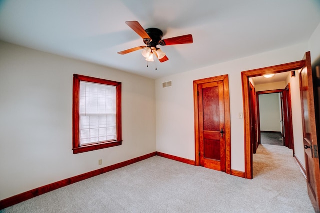 319 S 3rd St, Watseka, IL 60970 - unfurnished bedroom featuring carpet floors, baseboards, and a ceiling fan