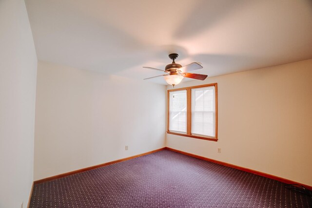 319 S 3rd St, Watseka, IL 60970 - empty room featuring dark carpet, a ceiling fan, and baseboards