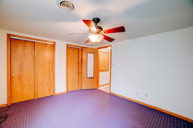 319 S 3rd St, Watseka, IL 60970 - unfurnished bedroom featuring multiple closets, carpet flooring, baseboards, and a ceiling fan