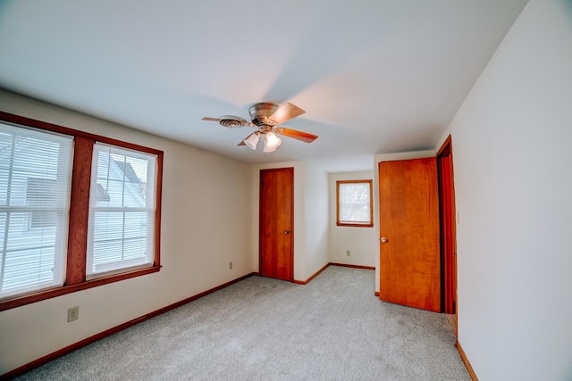 319 S 3rd St, Watseka, IL 60970 - unfurnished bedroom featuring multiple windows, light carpet, baseboards, and a closet