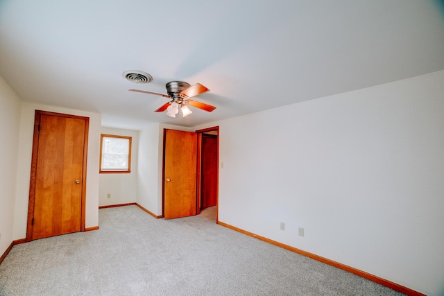 319 S 3rd St, Watseka, IL 60970 - unfurnished bedroom featuring baseboards, light colored carpet, and a ceiling fan