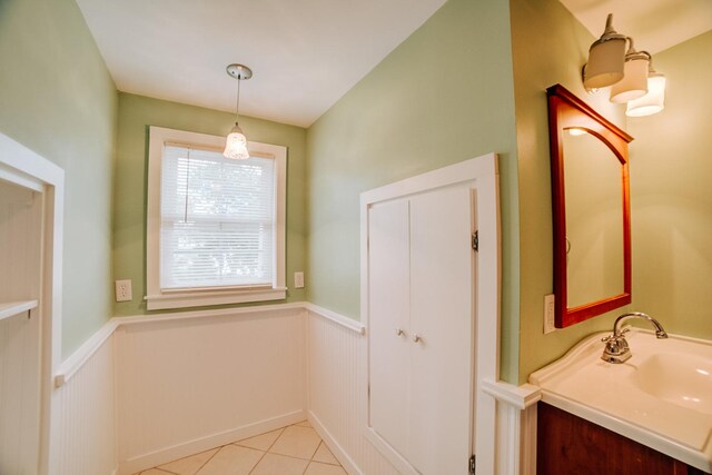 319 S 3rd St, Watseka, IL 60970 - bathroom featuring a wainscoted wall, tile patterned floors, and vanity