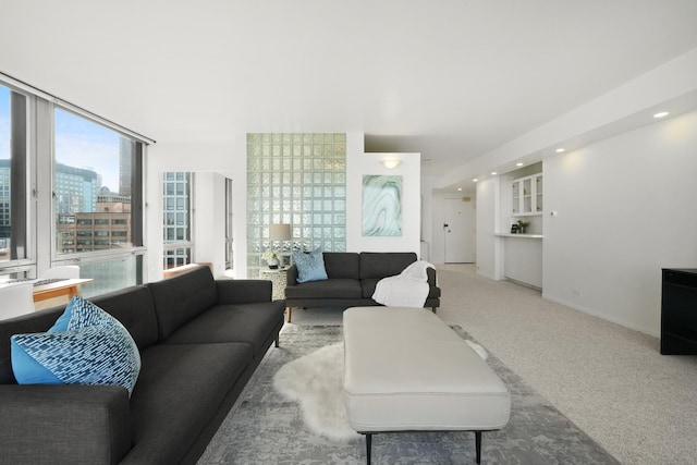 carpeted living area featuring recessed lighting and baseboards