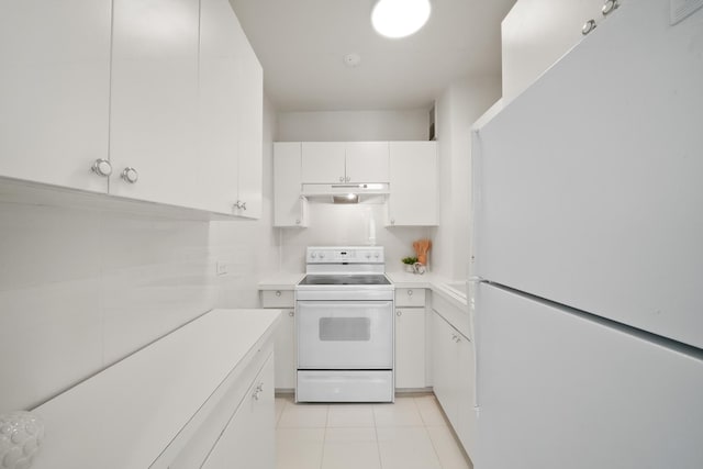 kitchen with under cabinet range hood, white appliances, white cabinetry, and light countertops