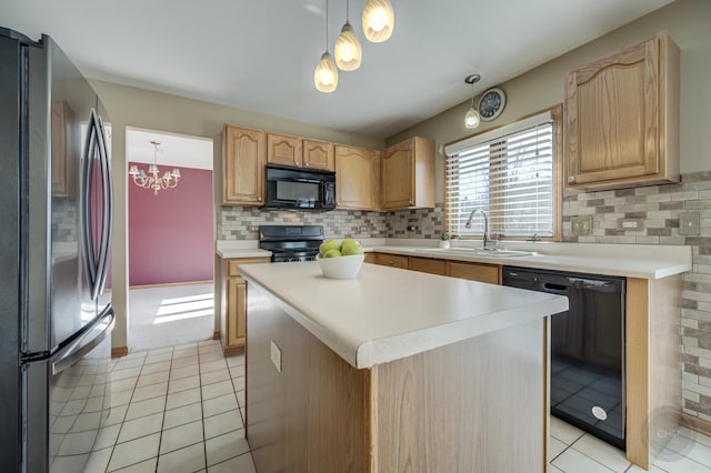 kitchen featuring backsplash, black appliances, light countertops, and a sink