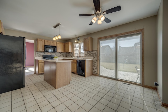 kitchen with visible vents, a kitchen island, black appliances, light countertops, and backsplash