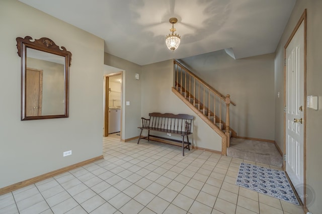 tiled foyer entrance with baseboards and stairs