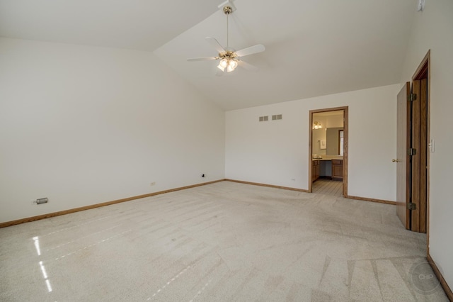 unfurnished bedroom featuring lofted ceiling, light colored carpet, baseboards, and visible vents