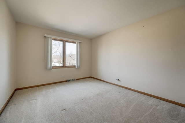 carpeted empty room with visible vents and baseboards