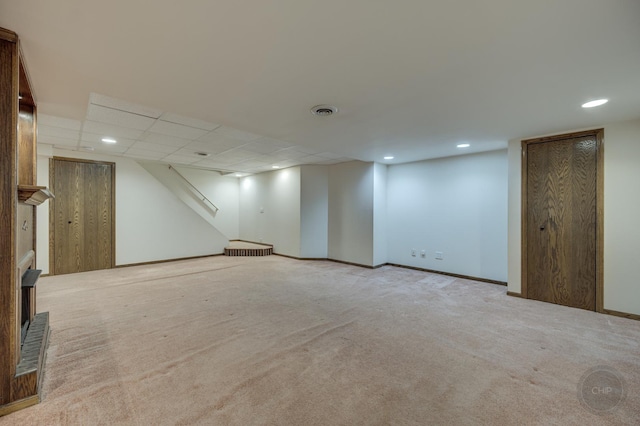 finished below grade area featuring recessed lighting, visible vents, baseboards, and carpet flooring