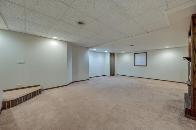 finished basement with visible vents, baseboards, light carpet, recessed lighting, and a paneled ceiling