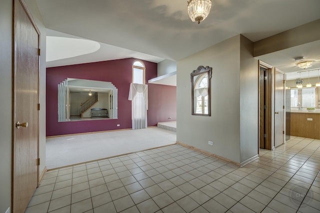 interior space with vaulted ceiling, baseboards, and carpet floors