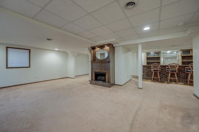 unfurnished living room featuring visible vents, a dry bar, and carpet floors