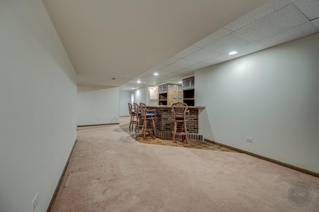 bar featuring a bar, carpet flooring, recessed lighting, and baseboards