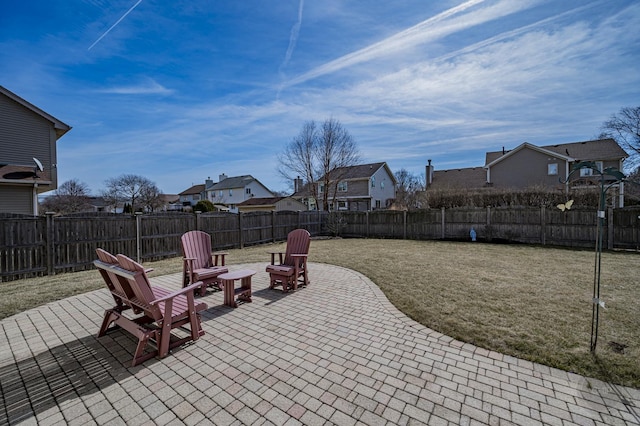 view of patio with a residential view, a fire pit, and a fenced backyard