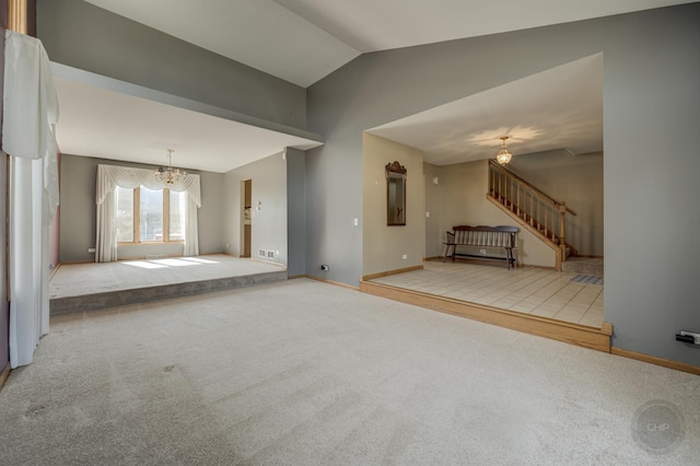 unfurnished living room featuring a chandelier, carpet flooring, stairway, and vaulted ceiling