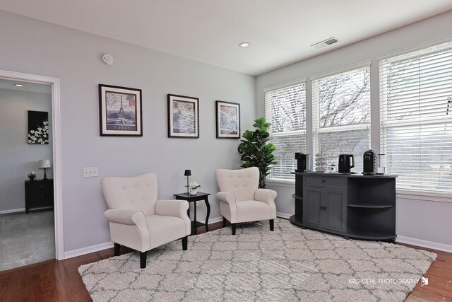 sitting room with recessed lighting, wood finished floors, visible vents, and baseboards