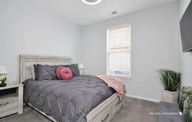 carpeted bedroom with visible vents and baseboards