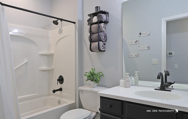 bathroom featuring toilet, shower / bath combo with shower curtain, and vanity