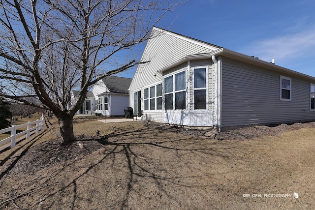 view of side of property featuring fence